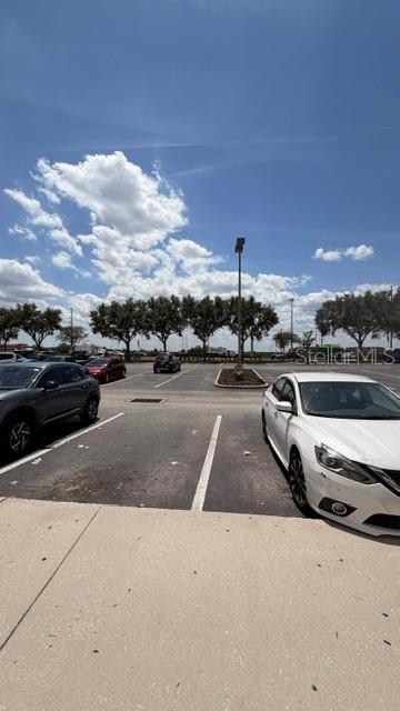 A parking lot with several parked cars under a bright blue sky — 42601 HIGHWAY 27, DAVENPORT, FL
