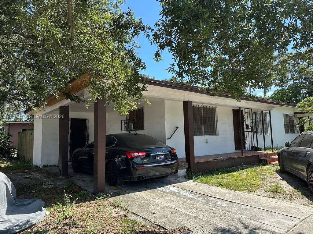 A single-story house with a carport, a front porch, and two parked cars — 545 NW 81st St, Miami FL 33150, MIAMI, FL