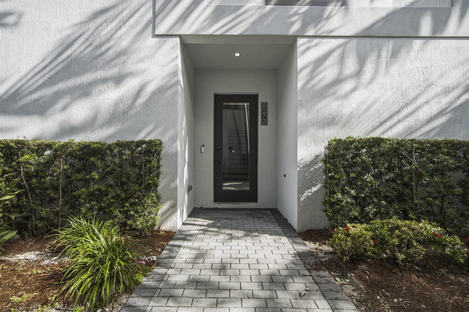 A paved walkway leads to the glass-paneled front door of a white stucco building — 8272 NW 44th Terrace, Doral FL 33166, DORAL, FL