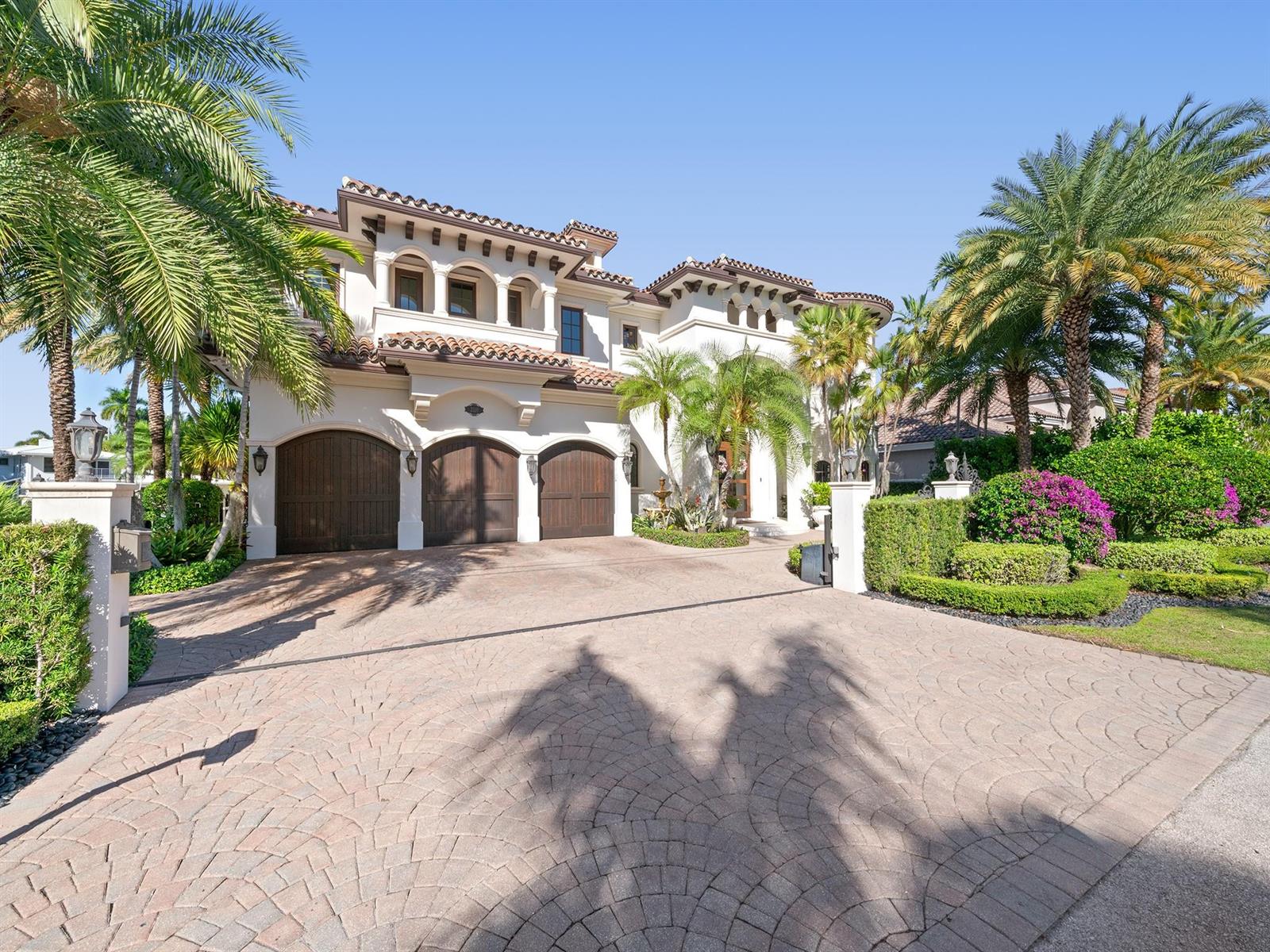 A large Mediterranean-style house features a three-car garage and a circular paved driveway — 2319 NE 28th Street, Lighthouse Point FL 33064, LIGHTHOUSE POINT, FL