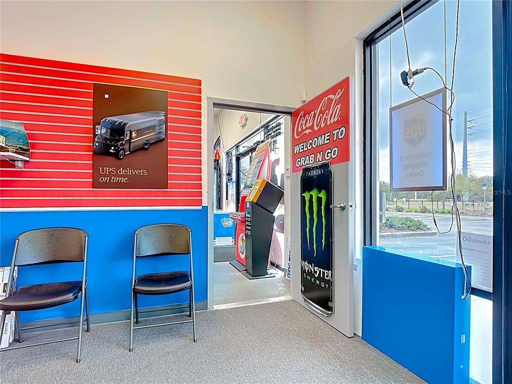 A small waiting area features two folding chairs, a UPS sign, and a doorway — 1372 S NARCOOSSEE ROAD, ST CLOUD, FL