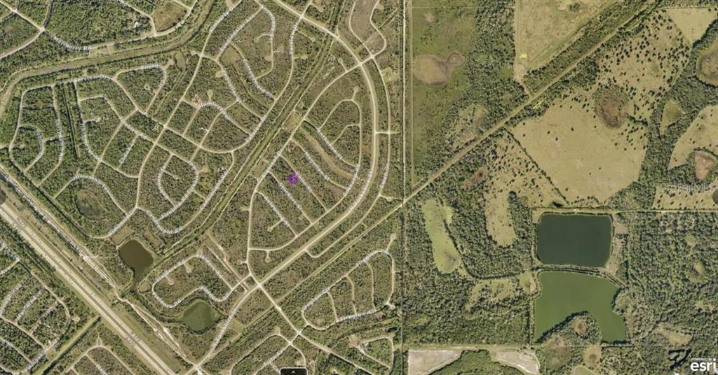 This is an aerial map view of a residential neighborhood with surrounding undeveloped land — 1130220018 CHILE STREET, NORTH PORT, FL