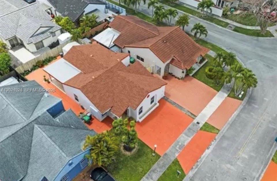 An aerial view shows two adjacent houses with red-tiled roofs and orange-painted driveways — 13440 SW 28th St, Miami FL 33175, MIAMI, FL