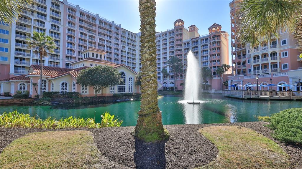 A fountain sprays water in a pond in front of large, multi-story resort buildings — 200 OCEAN CREST DRIVE UNIT 524, PALM COAST, FL