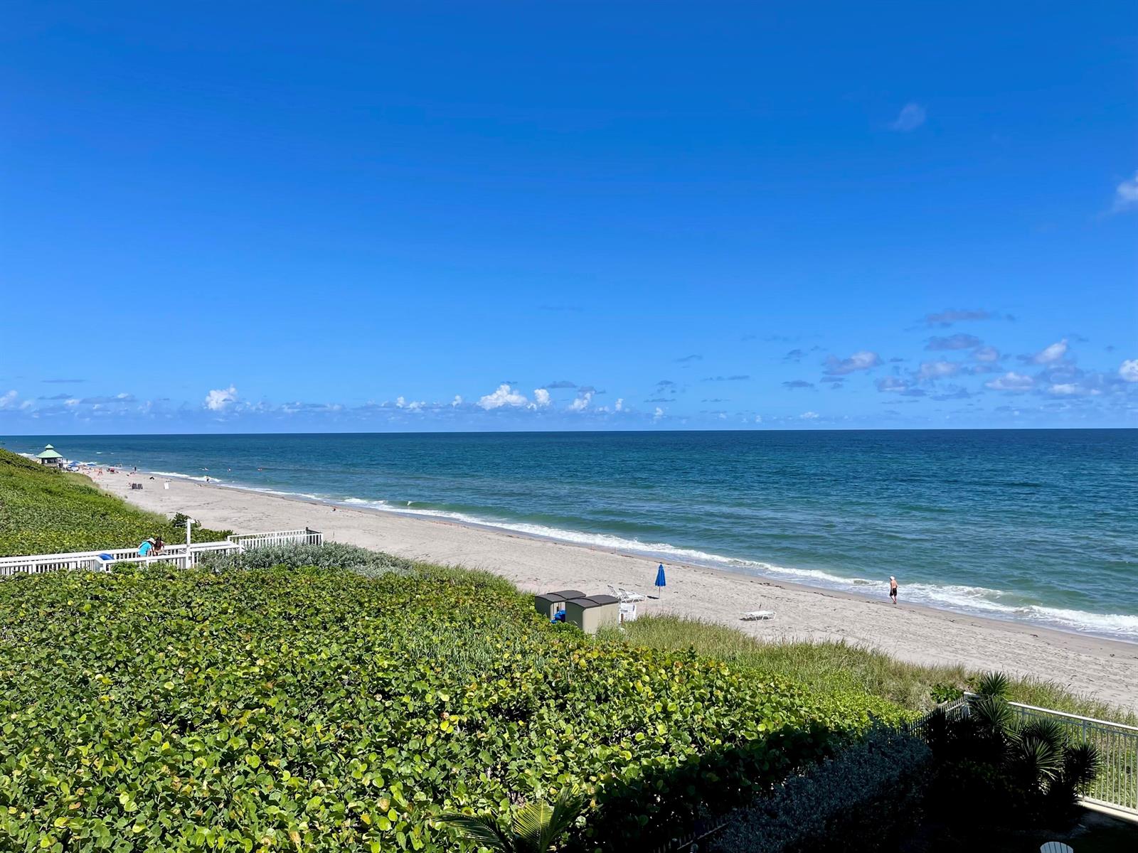 A view of a sandy beach and ocean from an elevated outdoor deck — 310 S Ocean Boulevard # 305, Boca Raton FL 33432, BOCA RATON, FL