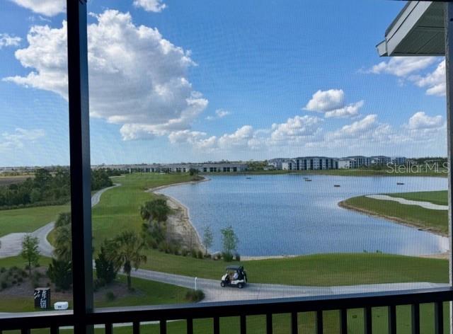 A view from a screened balcony overlooking a lake, golf course, and a golf cart — 12140 WELLEN GOLF STREET UNIT 402, VENICE, FL