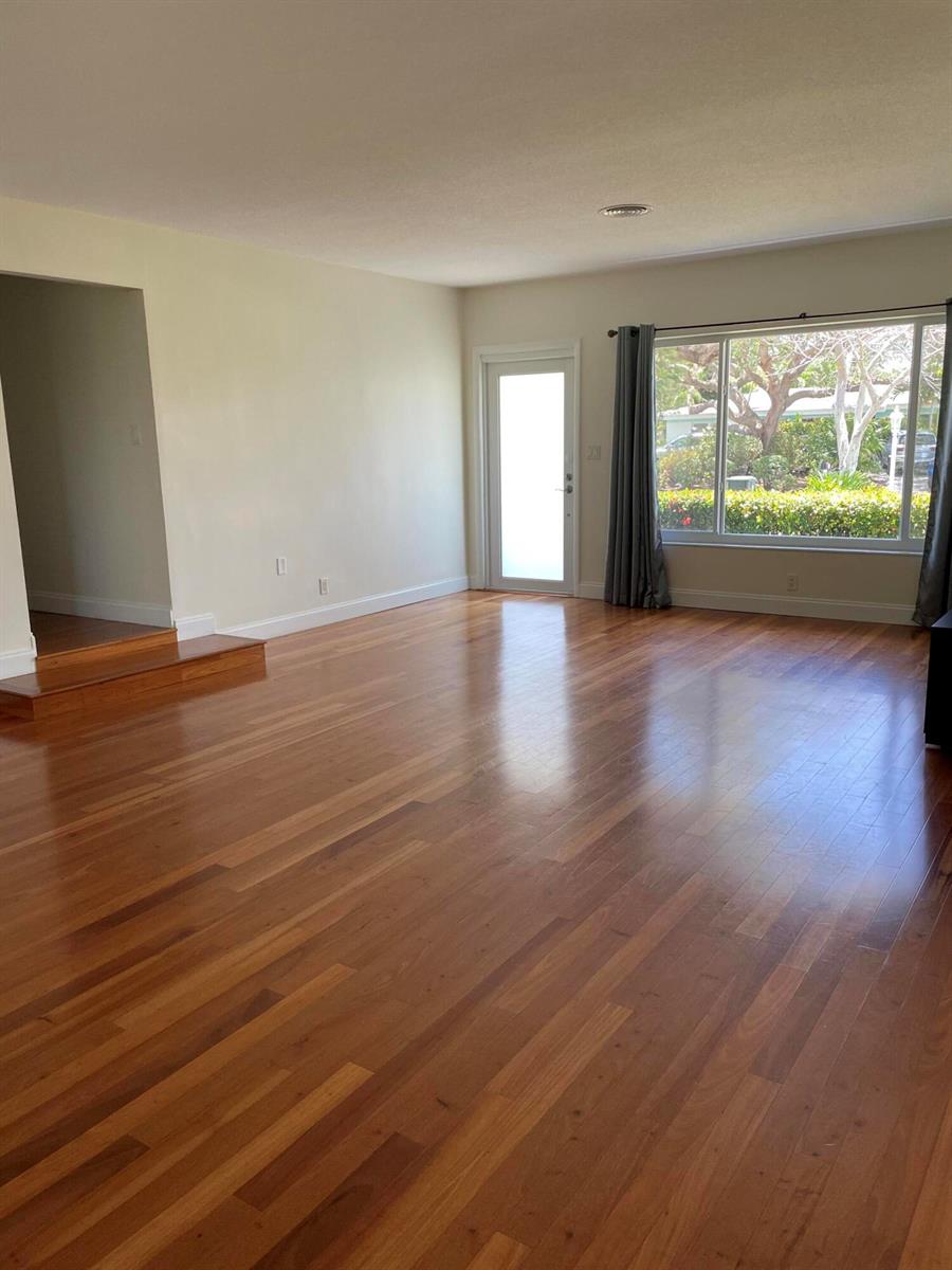 A living room features hardwood floors, a large window, a glass door, and a step-up entryway — 465 NE 34th Street, Boca Raton FL 33431, BOCA RATON, FL