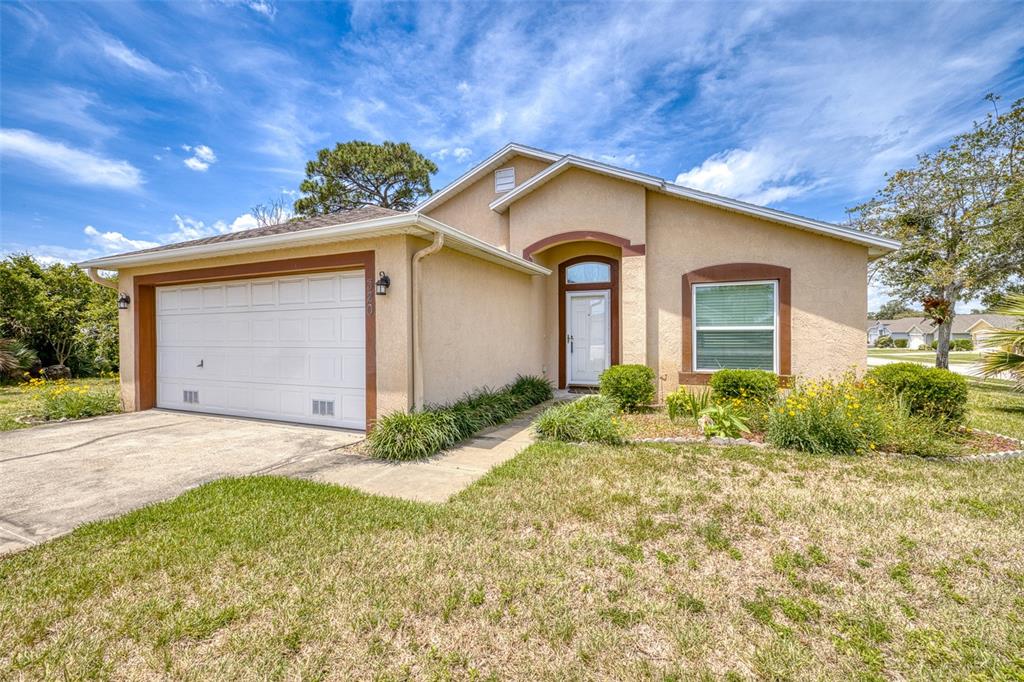 A single-story house with a beige stucco exterior, a one-car garage, and a front lawn — 320 BROKEN OAK DRIVE, EDGEWATER, FL., FL