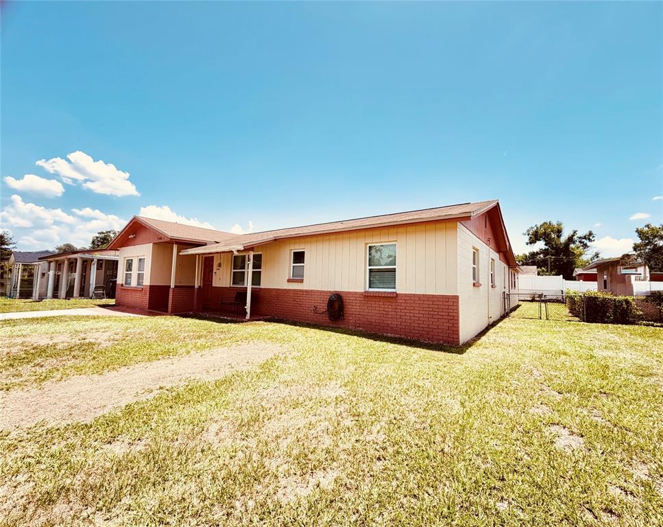A single-story house with a brick and siding exterior sits on a grassy lot — 3306 W BURKE STREET, TAMPA, FL