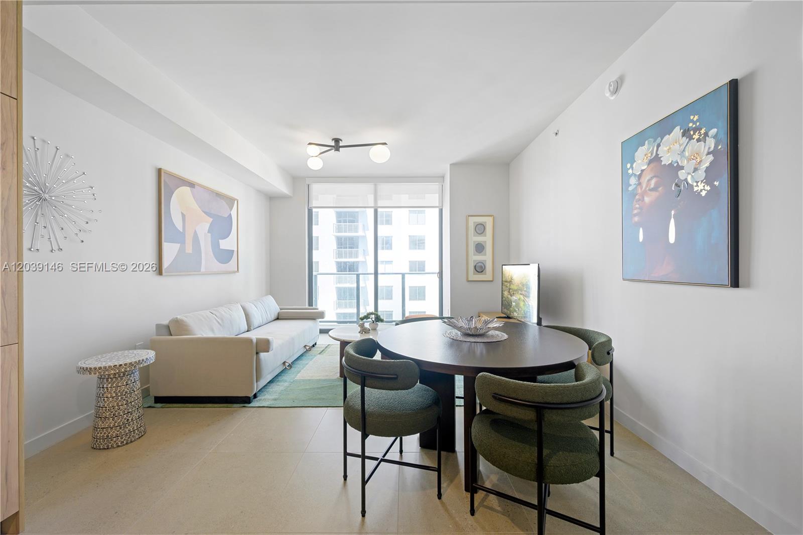 A living and dining room features a round table, green chairs, and a beige sofa — 11 NE 6th St # 1111, Miami FL 33132, MIAMI, FL