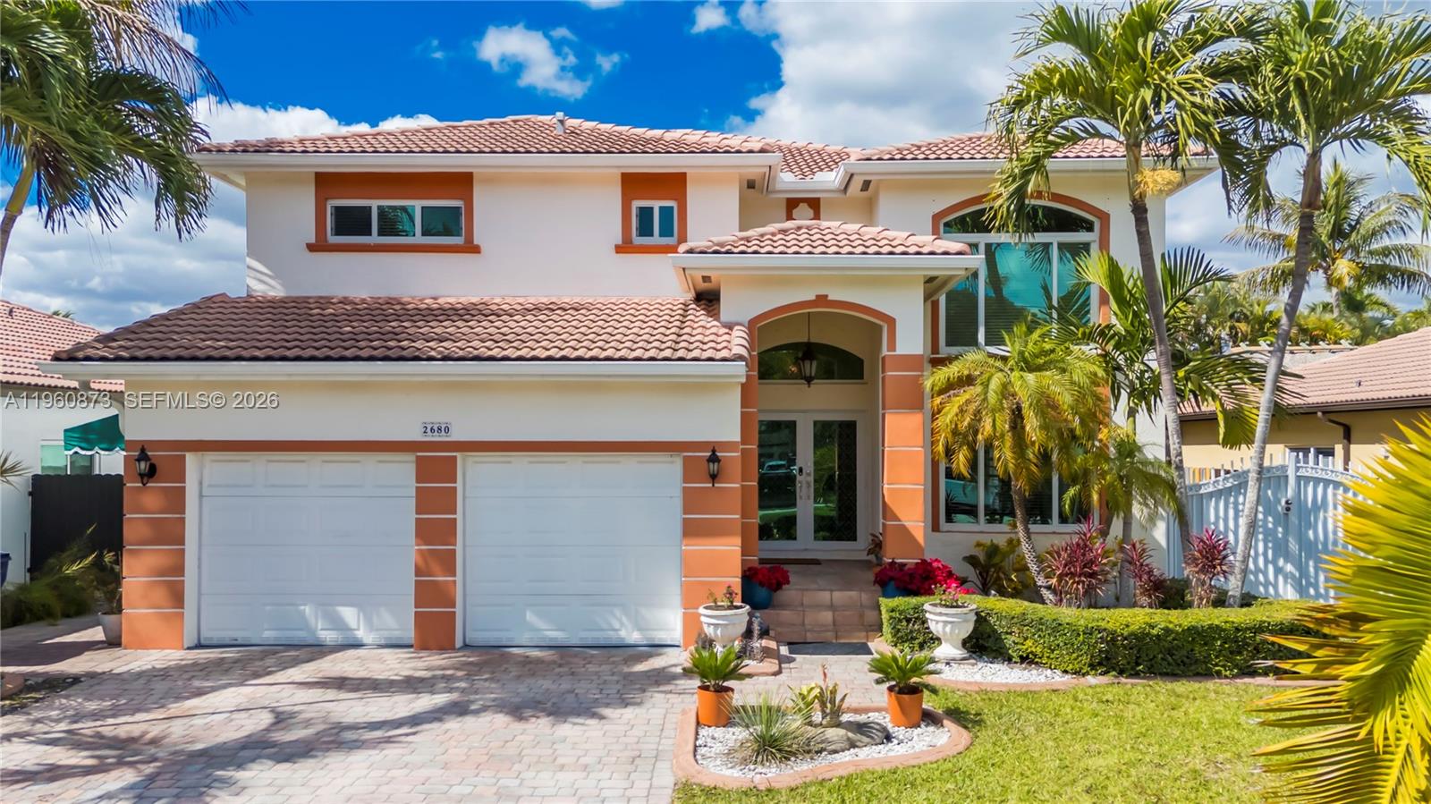 A two-story house with a tiled roof, orange trim, and a two-car garage — 2680 SW 142nd Ave, Miami FL 33175, MIAMI, FL