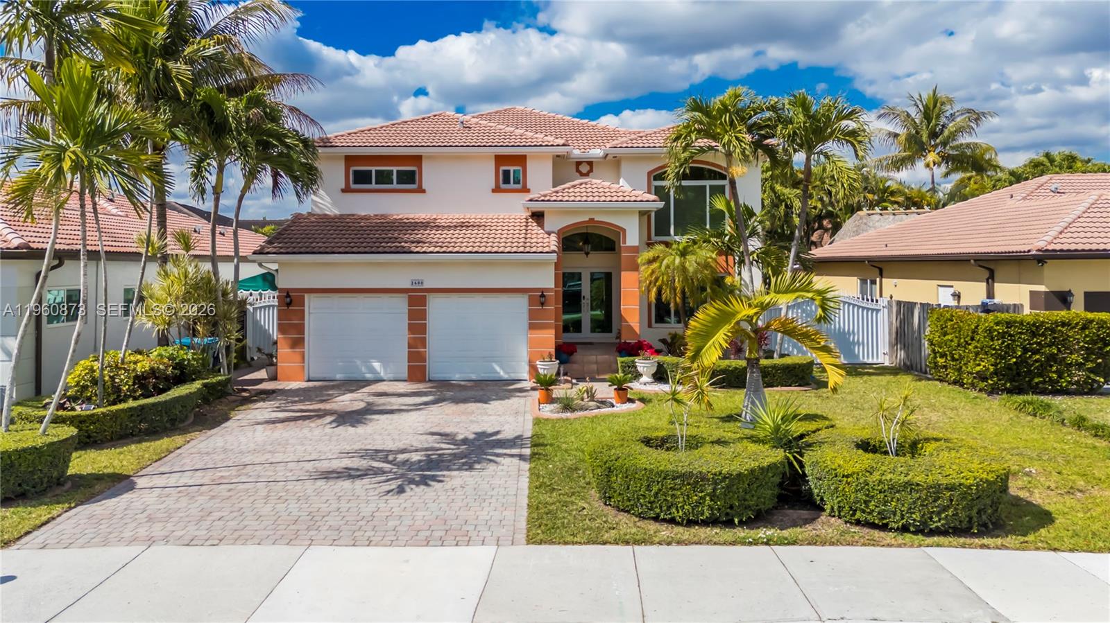 A two-story house with a tiled roof, a two-car garage, and landscaped front yard — 2680 SW 142nd Ave, Miami FL 33175, MIAMI, FL