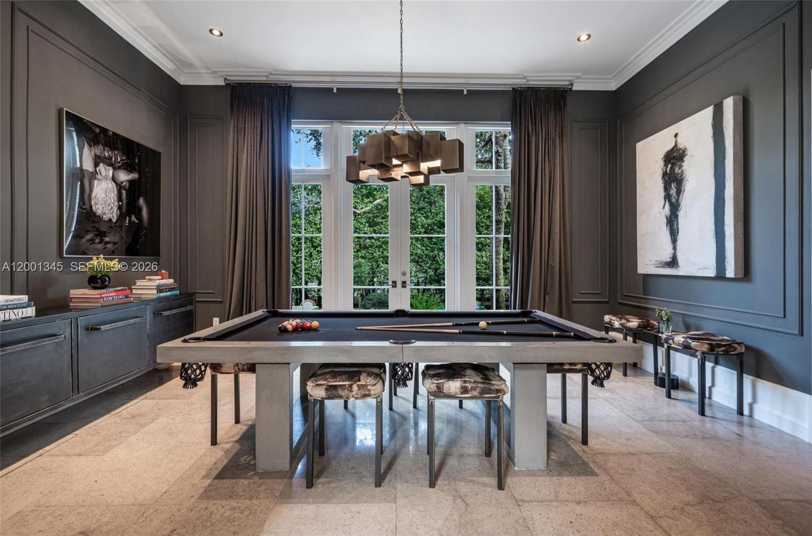A game room features a concrete pool table, dark gray walls, and floor-to-ceiling windows — 9741 W Suburban Dr, Pinecrest FL 33156, PINECREST, FL