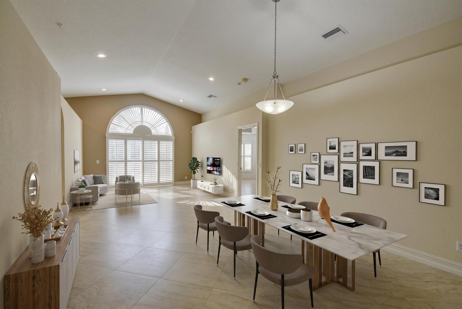 A dining area with a marble table and gallery wall opens into a bright living room — 18967 Treble Lane, Boca Raton FL 33498, BOCA RATON, FL