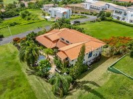 An aerial view of a house with a terracotta roof surrounded by a grassy yard — 13 MIRADOR NE UNIT 13, RIO GRANDE, PR