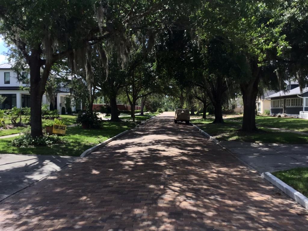 A brick-paved street is lined with large, moss-draped oak trees and residential houses — 120 BROADVIEW AVENUE, WINTER PARK, FL