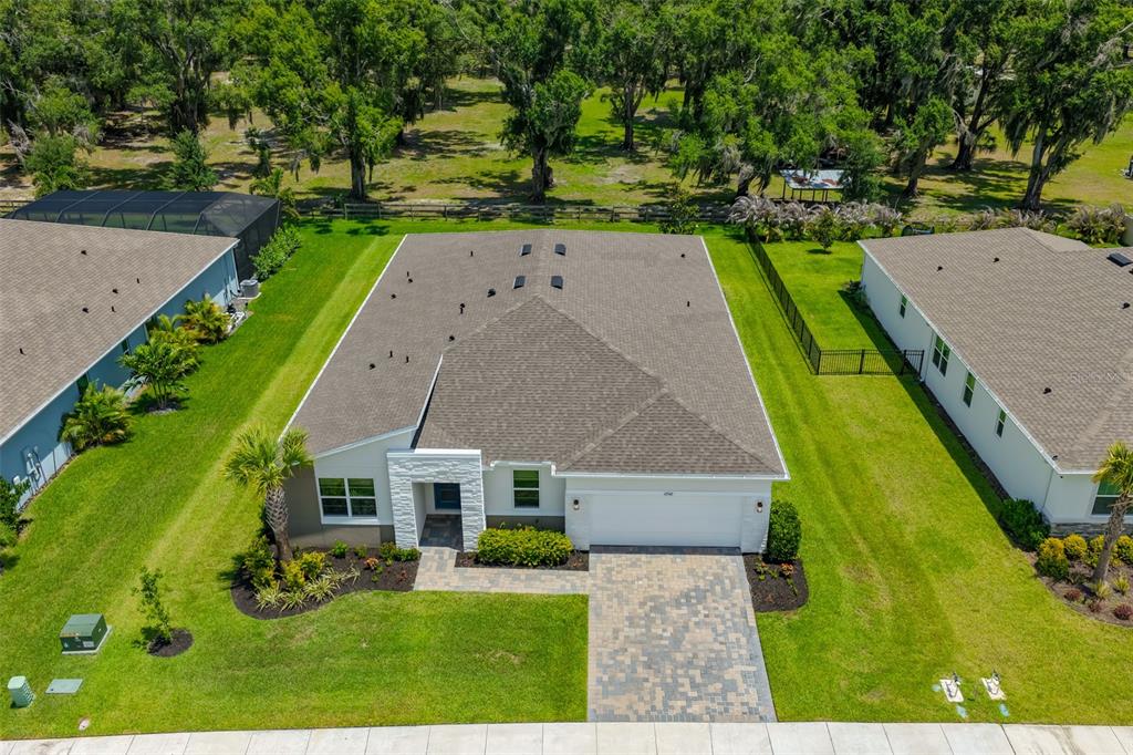 An aerial view shows a single-story house with a shingled roof and paved driveway — 12342 54TH STREET E, PARRISH, FL
