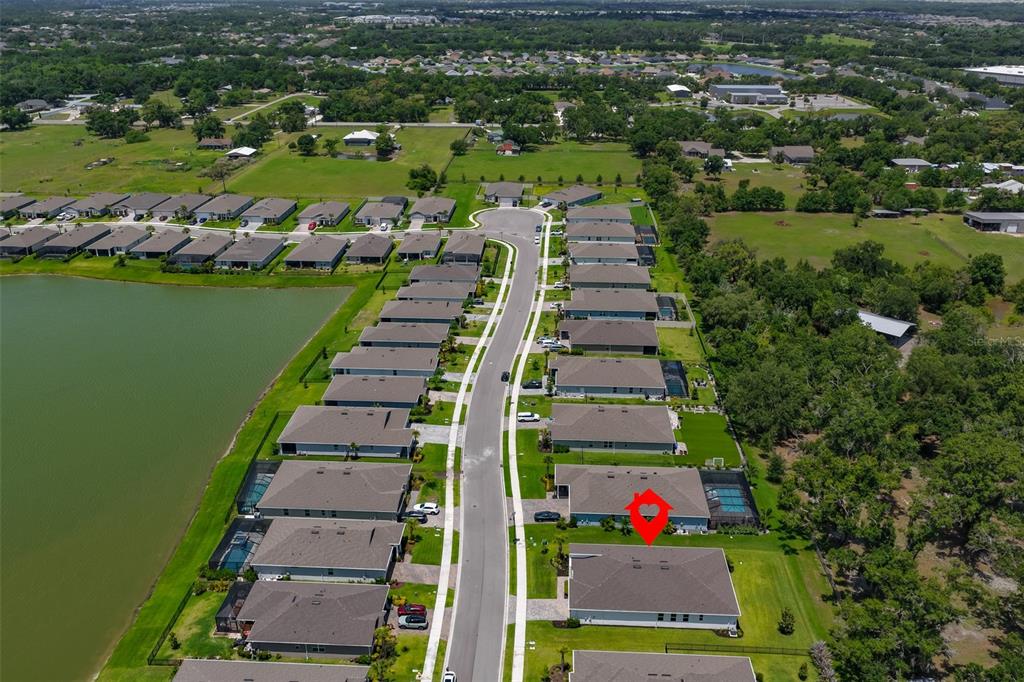 An aerial view shows a suburban neighborhood with a red marker highlighting a specific house — 12342 54TH STREET E, PARRISH, FL