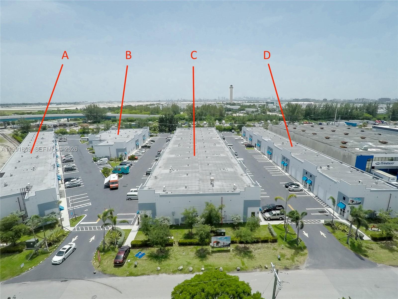 An aerial view shows four commercial warehouse buildings with parking lots and surrounding landscaping — 2355 NW 70th Ave # 3, Miami FL 33122, MIAMI, FL