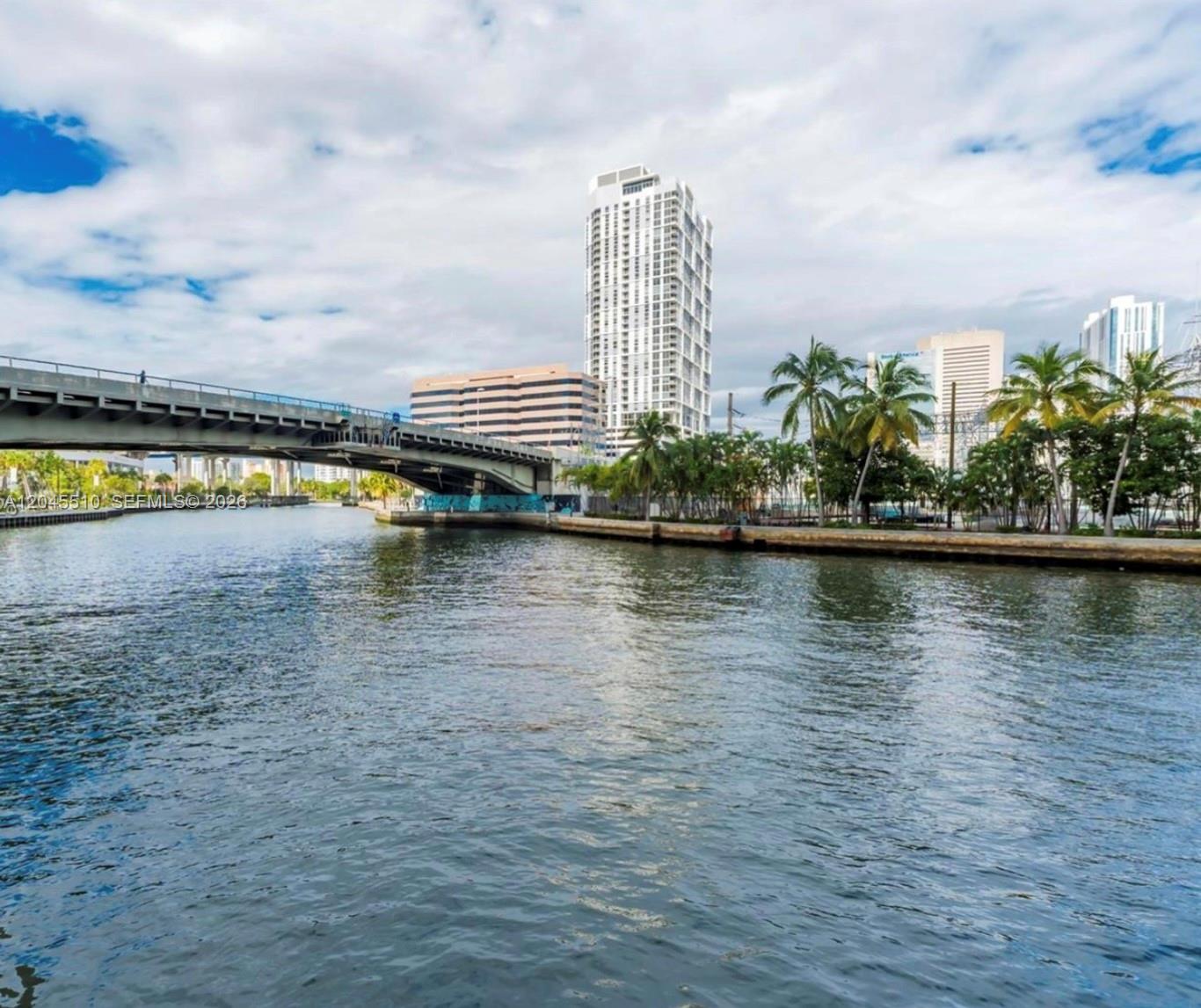 A view of a river with a bridge and city skyline in the background — 175 SW 7th St # 1212, Miami FL 33130, MIAMI, FL