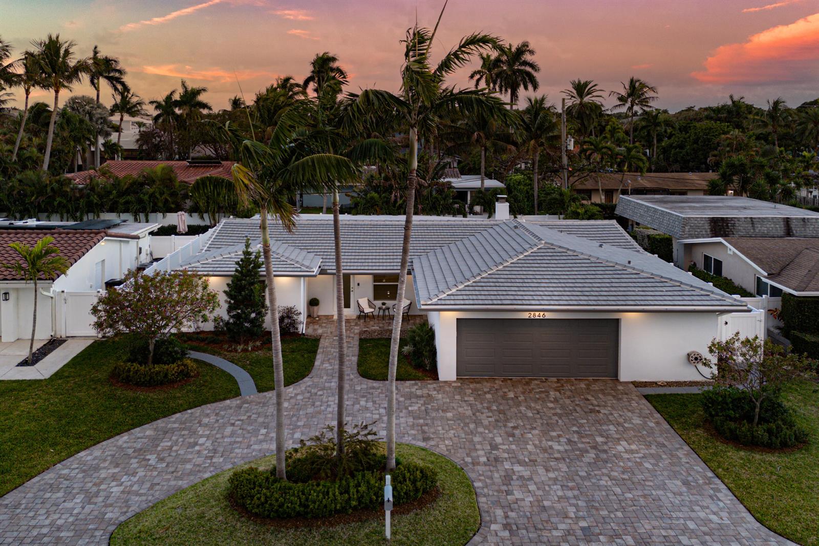 An aerial view of a single-story house with a gray tiled roof and paver driveway — 2846 NE 35th Court, Lighthouse Point FL 33064, LIGHTHOUSE POINT, FL