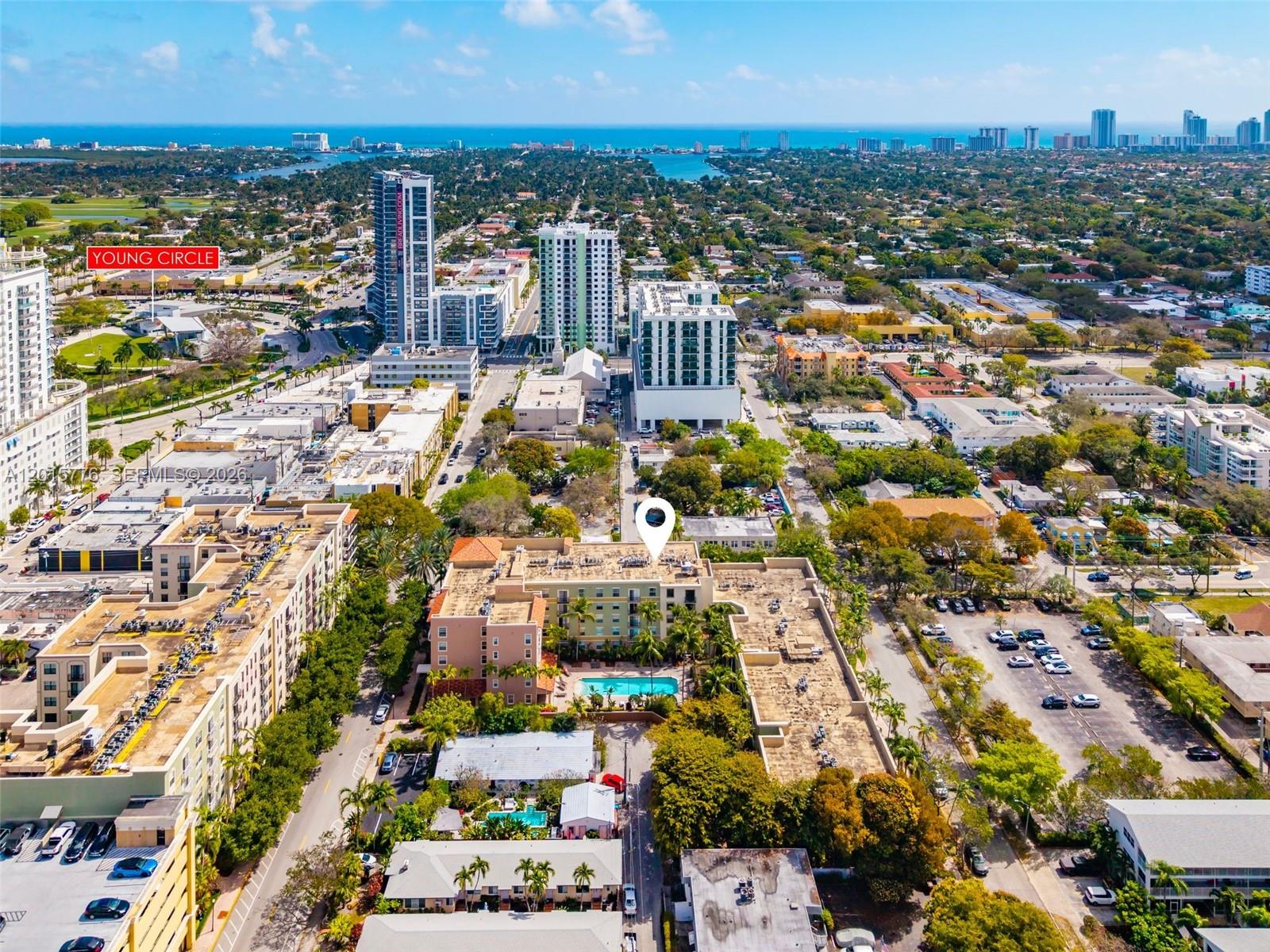 This is an aerial view of a multi-story apartment complex with a swimming pool — 1900 Van Buren St # 112B, Hollywood FL 33020, HOLLYWOOD, FL