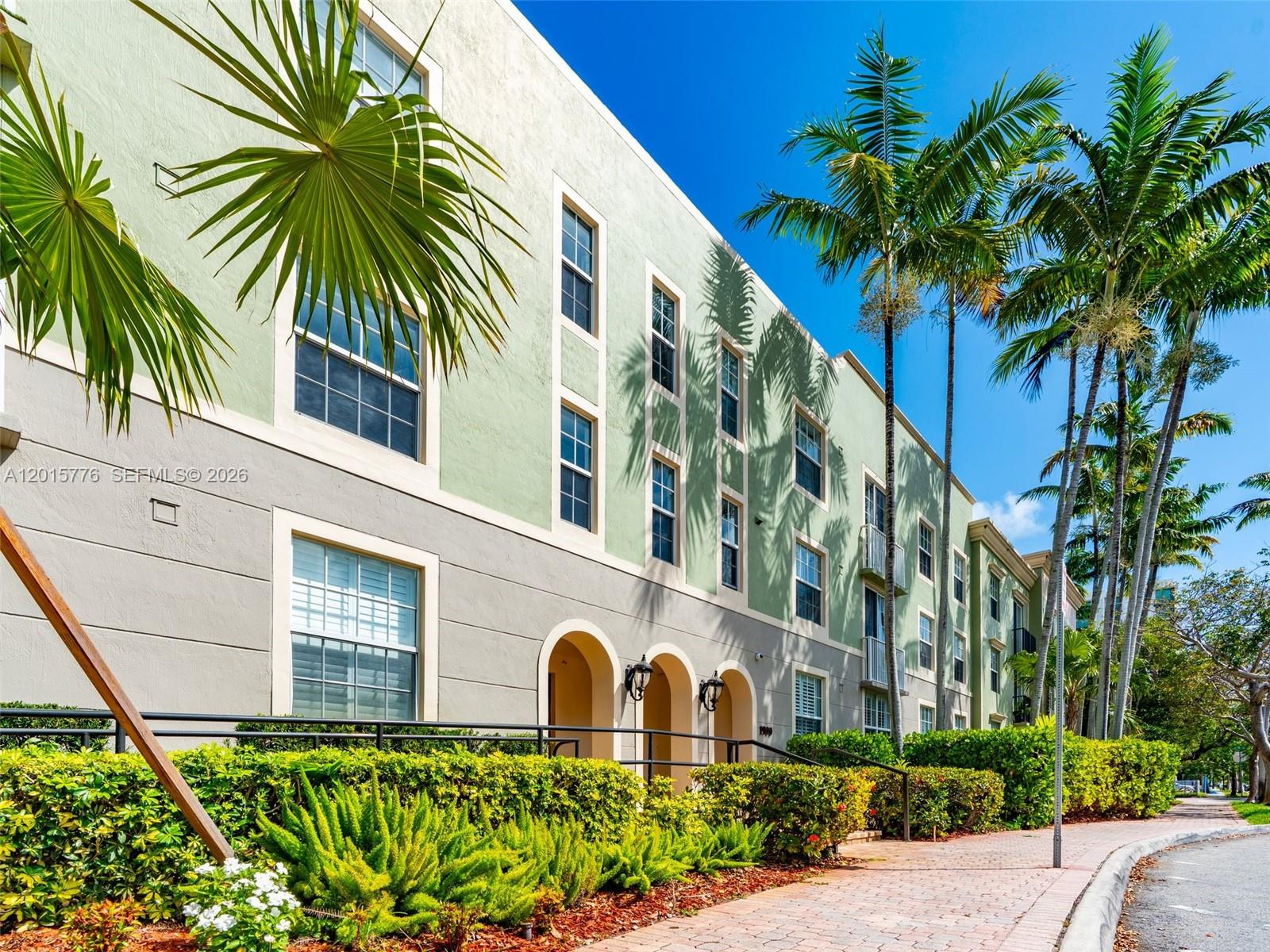 A multi-story apartment building with light green and beige stucco walls and palm trees — 1900 Van Buren St # 112B, Hollywood FL 33020, HOLLYWOOD, FL