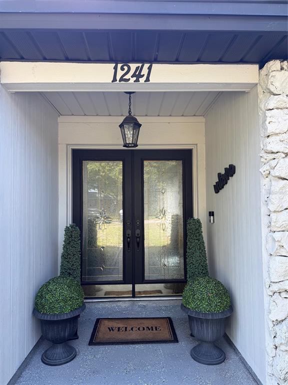 A single-story house with a stone facade, dark shutters, and a front lawn — 1241 ANGELINE AVENUE, ORLANDO, FL