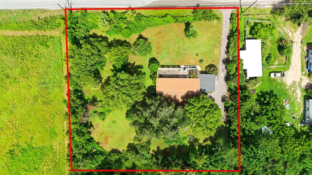 A single-story house with a covered porch sits on a large, grassy lot with trees — 403 S PARSONS AVENUE, SEFFNER, FL