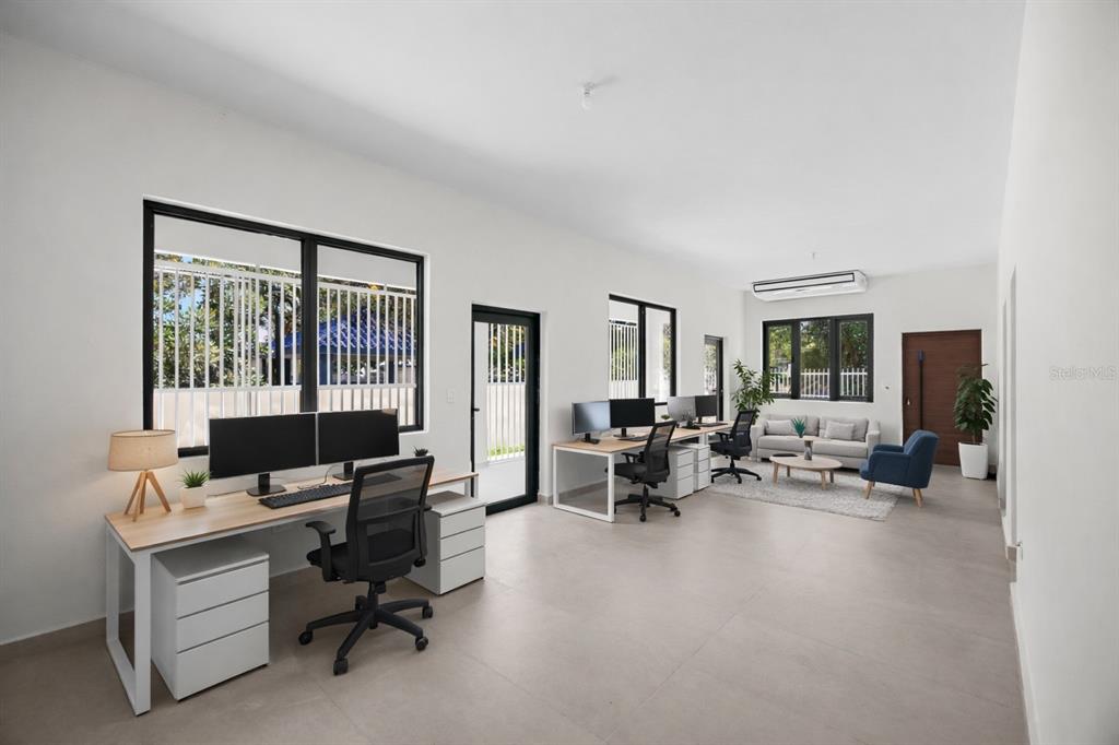 A modern office space features two workstations, a seating area, and large windows — 1207 LUCHETTI STREET, SAN JUAN, PR