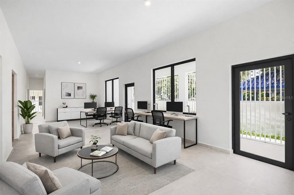 A modern office space features a lounge area, multiple workstations, and large windows with security bars — 1207 LUCHETTI STREET, SAN JUAN, PR