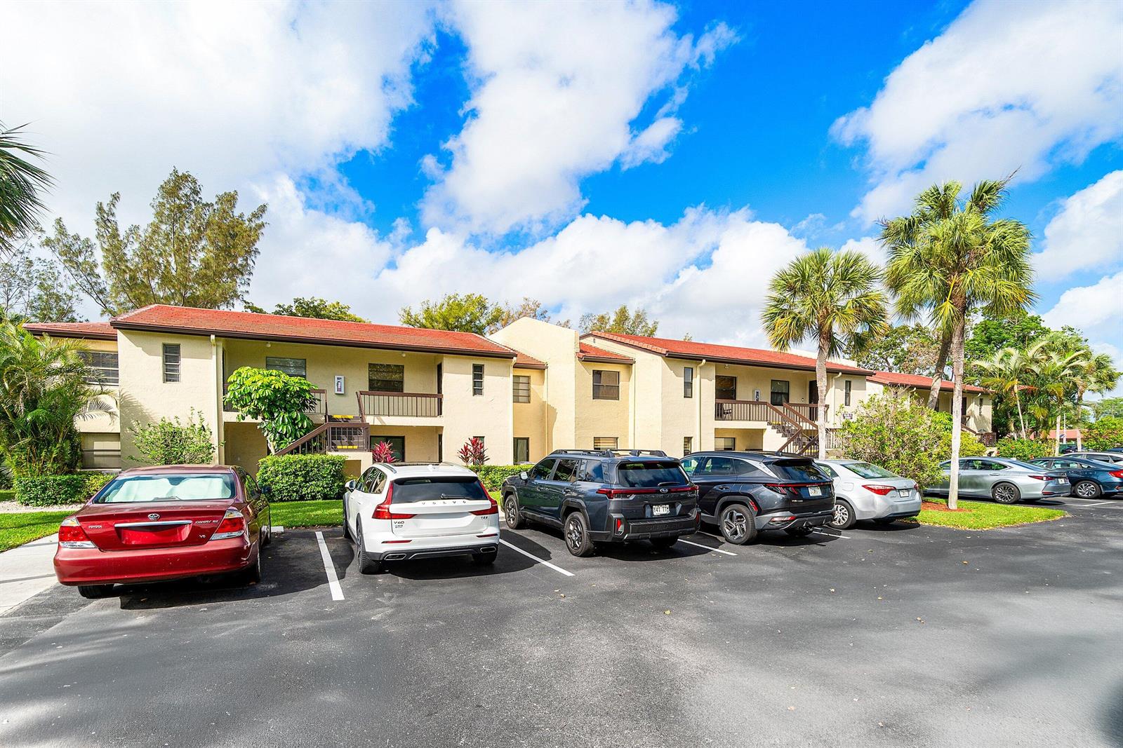 A two-story apartment building with a red tile roof overlooks a parking lot — 8320 Casa Del Lago # D, Boca Raton FL 33433, BOCA RATON, FL