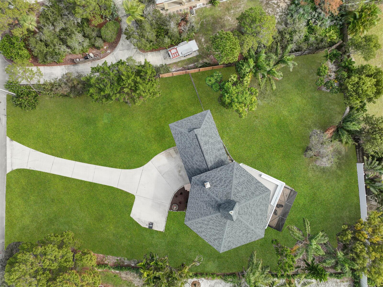 An aerial view shows a house with a gray roof, a driveway, and a large yard — 9752 SE Highborne Way, Hobe Sound FL 33455, HOBE SOUND, FL