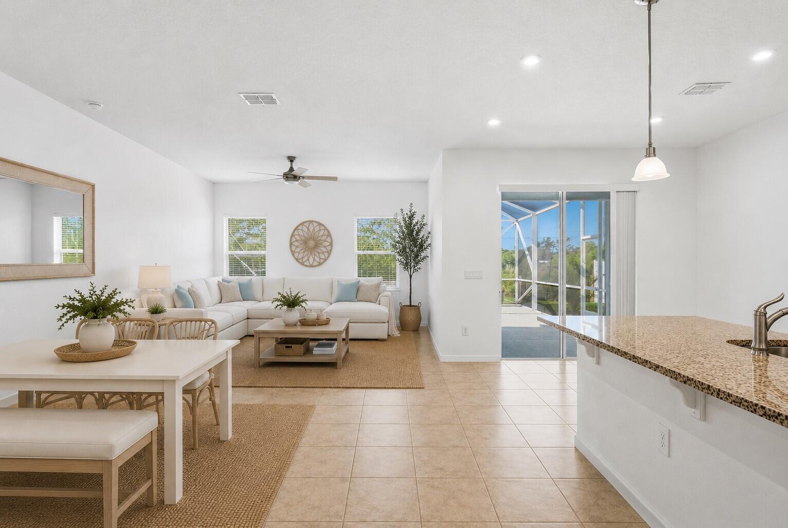 An open-concept living and dining area with tile floors, white walls, and a sliding door — 4213 Keeson Circle, Vero Beach FL 32967, VERO BEACH, FL