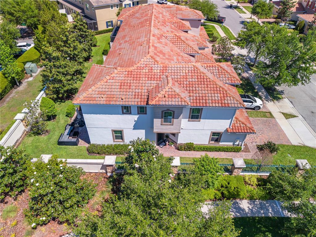 An aerial view of a two-story house with a red tile roof and white exterior — 14100 TARVIN STREET, ORLANDO, FL