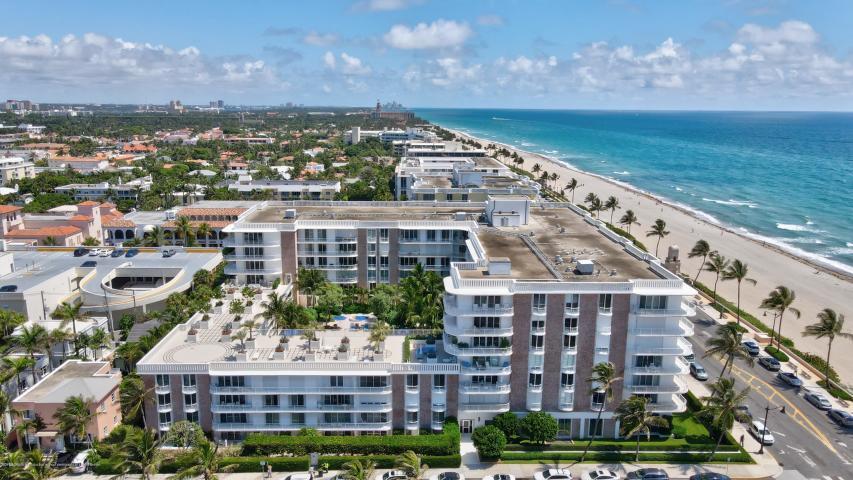 An aerial view of a multi-story apartment building located next to a sandy beach — 100 Worth Avenue # 7, Palm Beach FL 33480, PALM BEACH, FL
