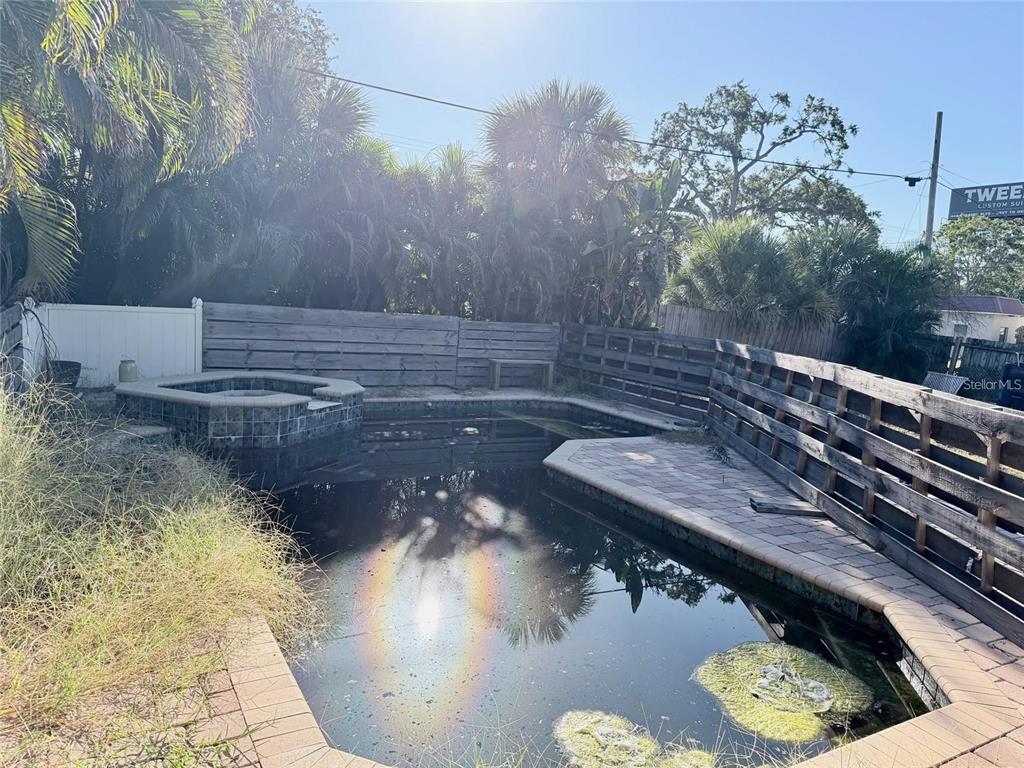 A backyard swimming pool with a raised spa and a wooden privacy fence — 3626 S OMAR AVENUE, TAMPA, FL