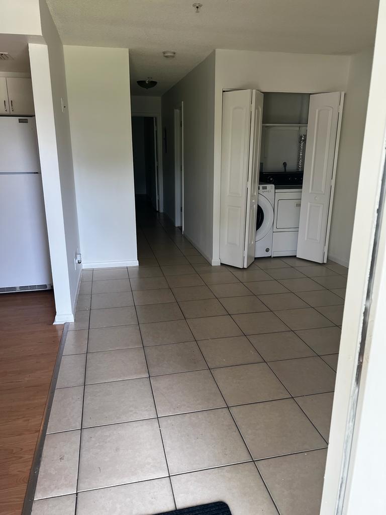 A tiled entryway leads to a laundry closet with folding doors and a hallway beyond — 4429 Melvin Road # A, FL 33461, FL