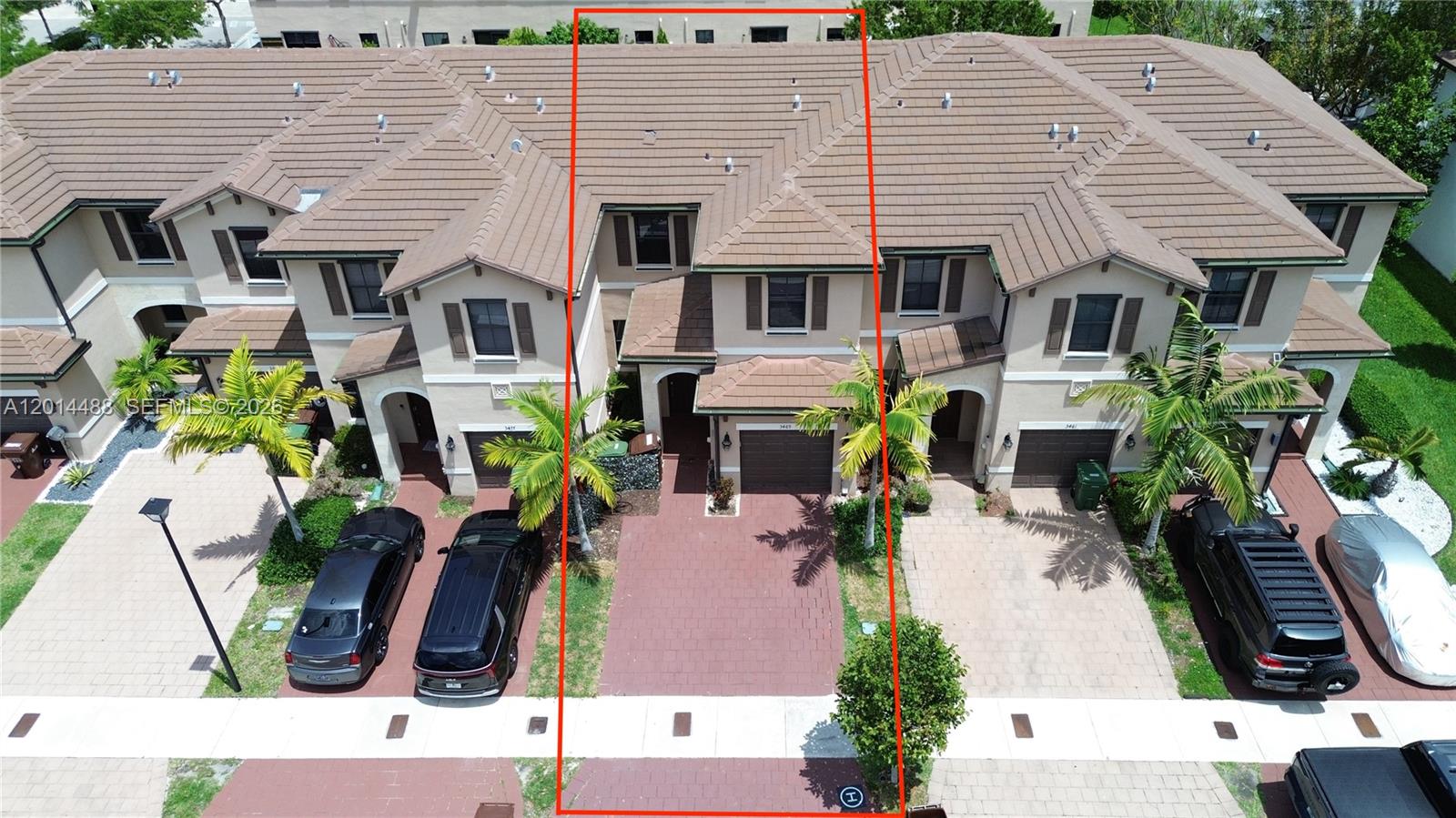 An aerial view shows a row of townhouses with brown tile roofs and paved driveways — 3469 W 106th St, Hialeah FL 33018, HIALEAH, FL