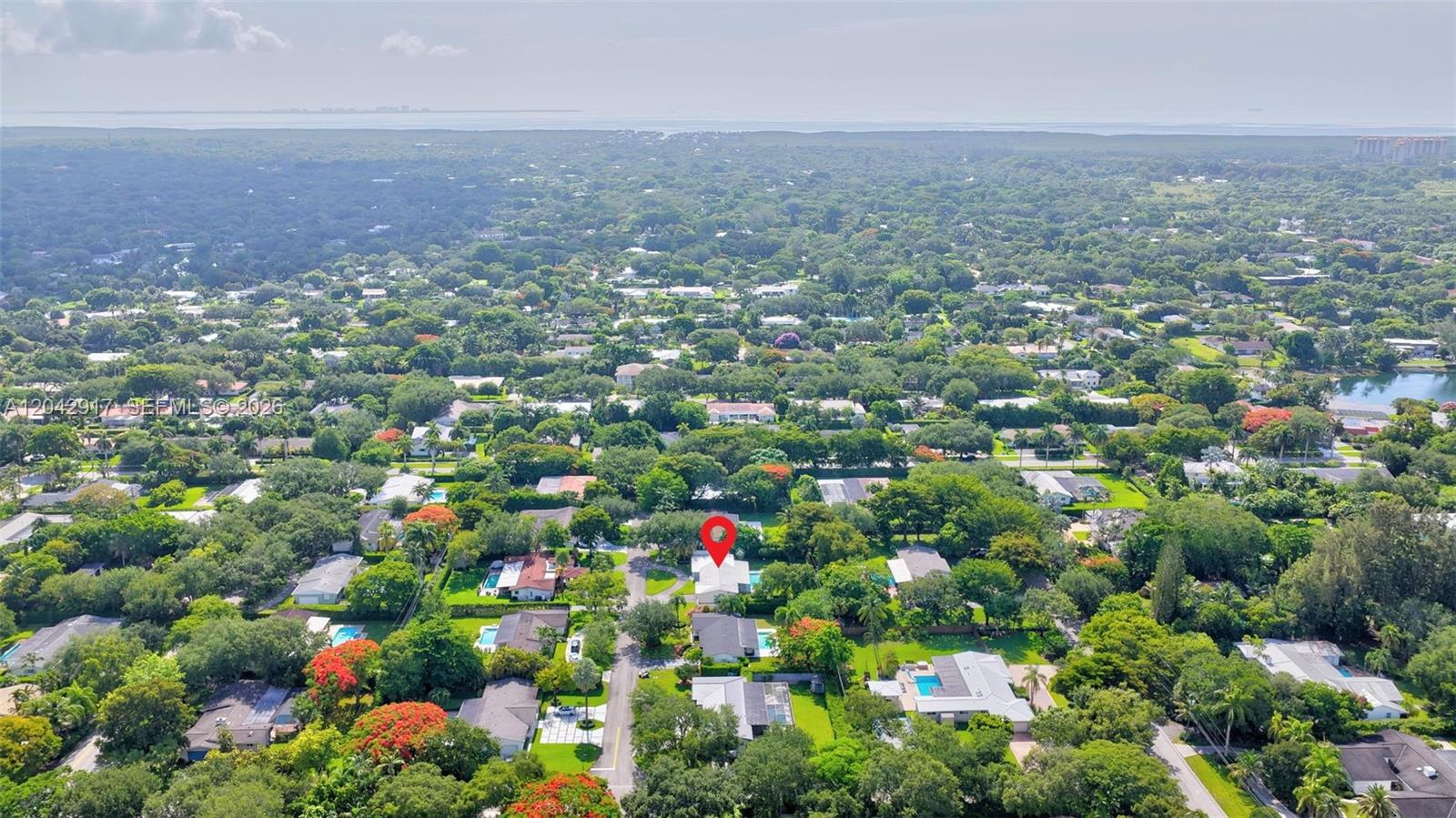 An aerial view shows a residential neighborhood with a red pin marking a house — 7240 SW 131st St, Pinecrest FL 33156, PINECREST, FL