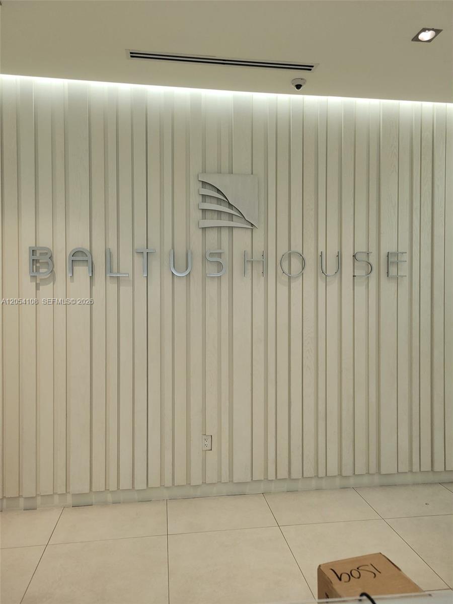 A wall with vertical wood paneling features the Baltus House logo and name in a lobby — 4250 Biscayne Blvd # 806, Miami FL 33137, MIAMI, FL