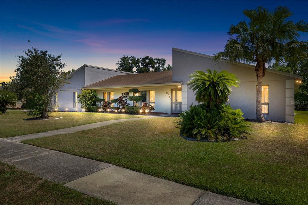 A single-story house with a slanted roofline and a palm tree in the front yard — 34 MISTY MEADOW LANE, MULBERRY, FL