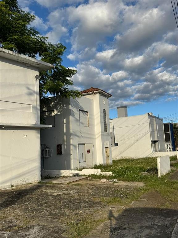 A view of the exterior of white, multi-story buildings with flat roofs and boarded windows — 39 AVENIDA MAYAGUEZ, SAN JUAN, PR