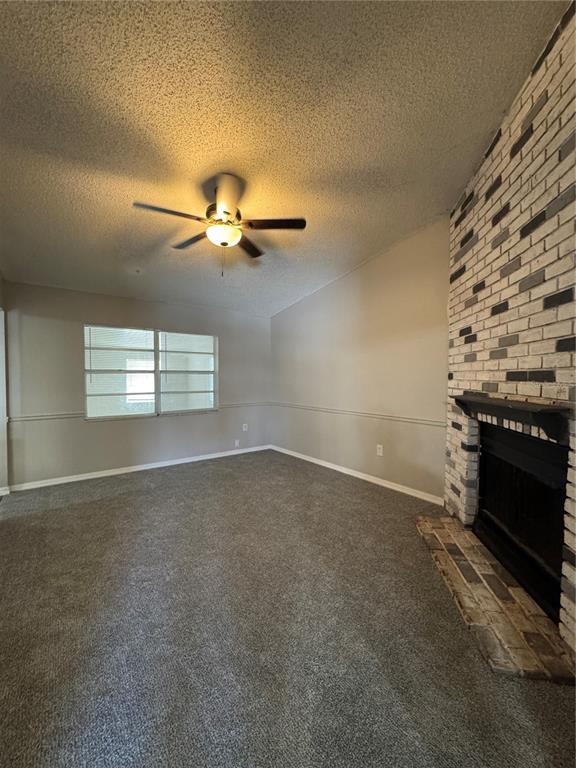 A living room features gray carpet, a brick fireplace, and a ceiling fan — 721 GREENLEAF LANE, LAKE WALES, FL