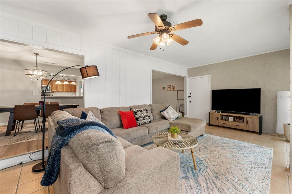 A living room features a sectional sofa, a television on a console, and a ceiling fan — 2660 SW 14TH DRIVE UNIT 125, GAINESVILLE, FL