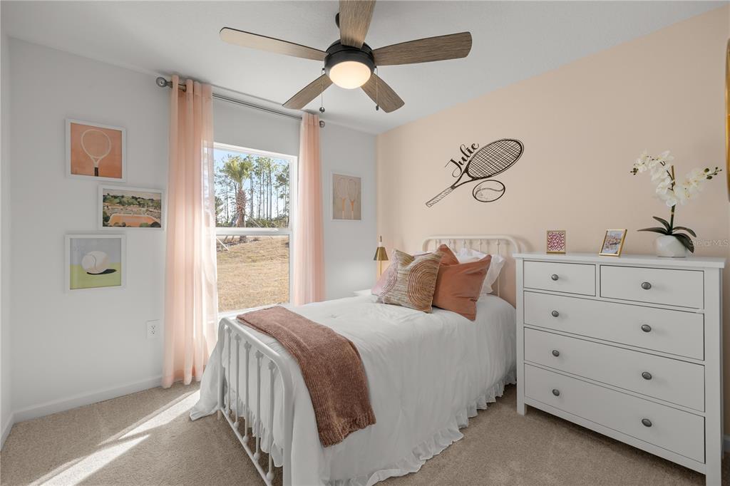 A bedroom features a twin bed, a white dresser, and tennis-themed wall decor — 4239 SW 82ND LANE, OCALA, FL