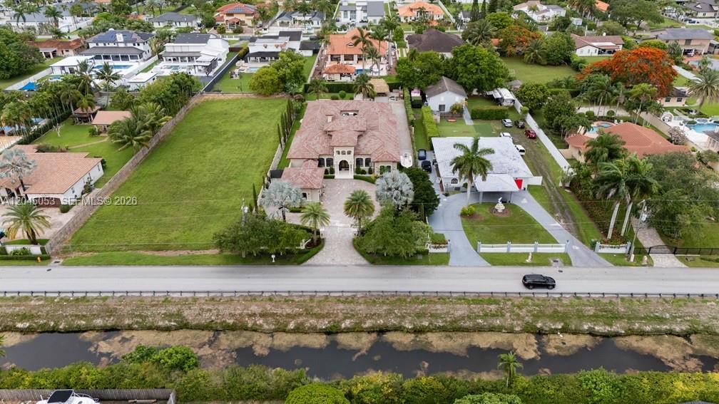 An aerial view shows a large house with a tile roof, a pool, and landscaping — 2835 SW 132nd Ave, Miami FL 33175, MIAMI, FL