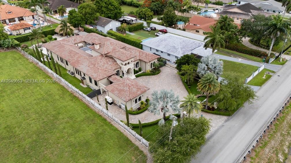 An aerial view shows a large house with a tiled roof and a paved driveway — 2835 SW 132nd Ave, Miami FL 33175, MIAMI, FL