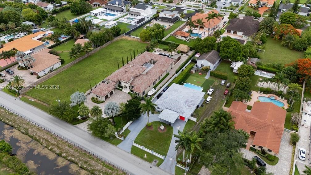 An aerial view shows several suburban houses with swimming pools and large green lawns — 2835 SW 132nd Ave, Miami FL 33175, MIAMI, FL