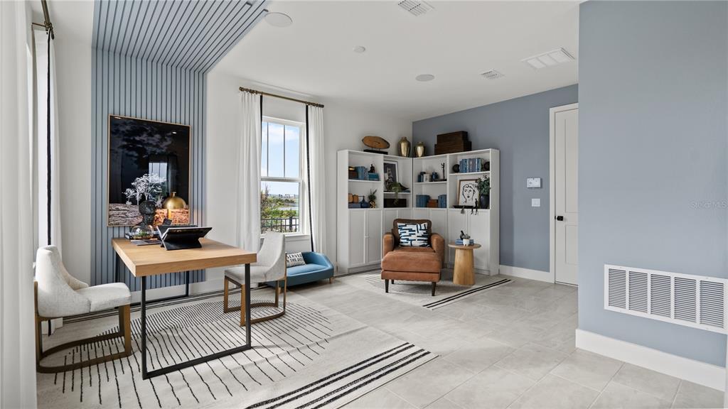 A home office features a wooden desk, built-in shelving, a leather armchair, and blue accents — 15153 GROVESIDE ROAD, WINTER GARDEN, FL